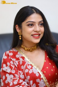 Indian Actress Varsha Bollamma in a red dress