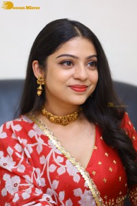 Indian Actress Varsha Bollamma in a red dress