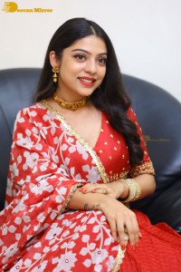 Indian Actress Varsha Bollamma in a red dress