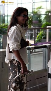 actress wamiqa gabbi chic look in white shirt and sunglasses at airport
