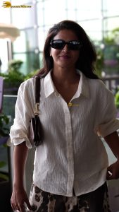 actress wamiqa gabbi chic look in white shirt and sunglasses at airport