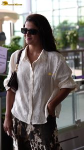 actress wamiqa gabbi chic look in white shirt and sunglasses at airport