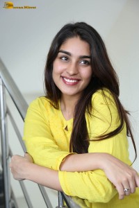 actress yukti thareja cute in a white kurti and torn black jeans