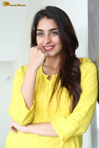 actress yukti thareja cute in a white kurti and torn black jeans
