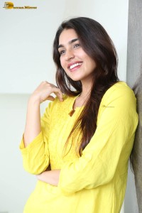 actress yukti thareja cute in a white kurti and torn black jeans
