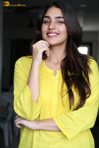 actress yukti thareja cute in a white kurti and torn black jeans