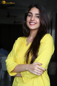 actress yukti thareja cute in a white kurti and torn black jeans