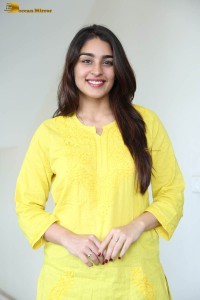 actress yukti thareja cute in a white kurti and torn black jeans