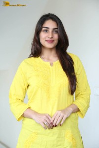 actress yukti thareja cute in a white kurti and torn black jeans