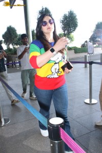 actress Zareen Khan in a colorful t-shirt and jeans at mumbai airport