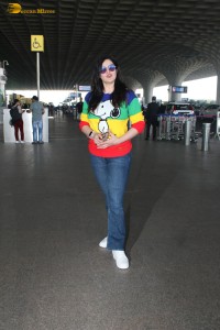 actress Zareen Khan in a colorful t-shirt and jeans at mumbai airport