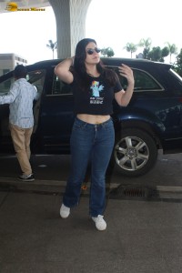 actress Zareen Khan in a short t-shirt and jeans